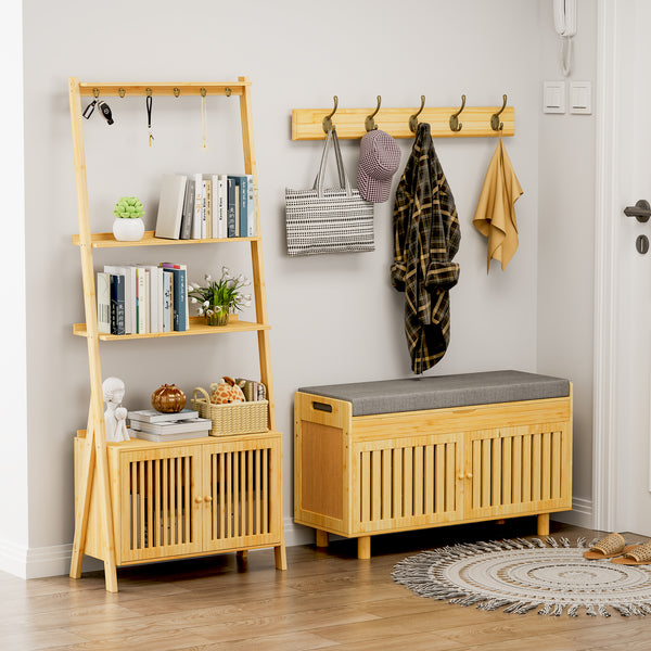 A stylish entryway featuring bamboo shelves with books and decor, a bench with a cushioned top, and hooks for hanging bags and clothing.
