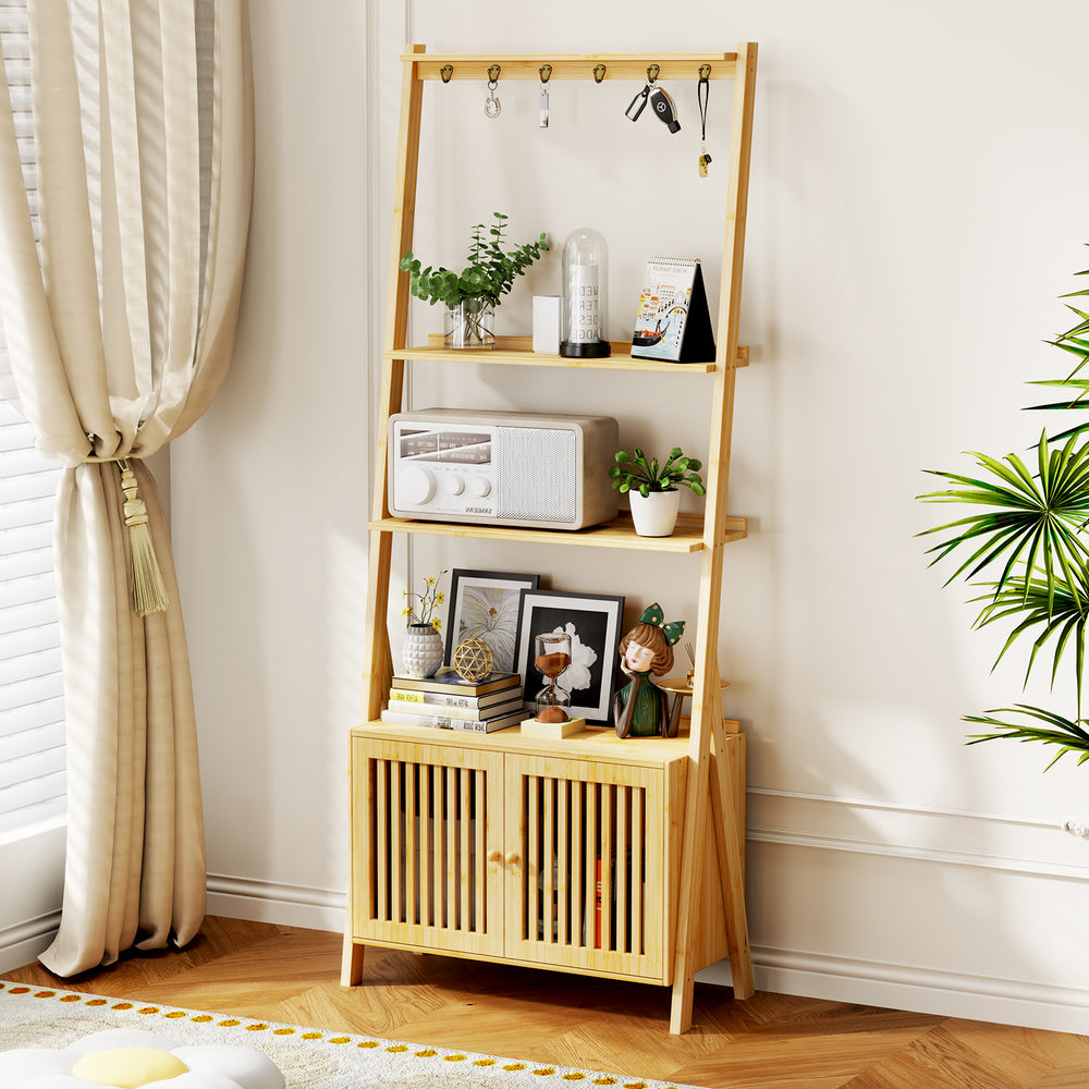 A stylish wooden shelf with plants, a radio, photos, and decor, featuring a lower cabinet with slatted doors beside a sunny window.