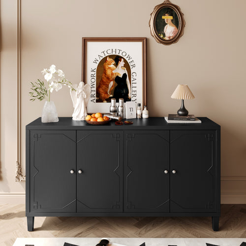 A stylish black cabinet adorned with a decorative vase, fruit bowl, lamp, and framed artwork against a soft beige wall.