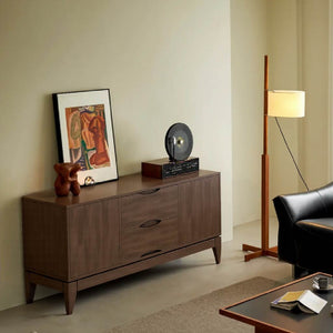 A stylish living room corner featuring a wooden cabinet, framed art, a vinyl record player, a floor lamp, and a black armchair.
