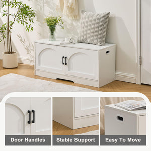 Modern white storage cabinet with arched doors, black handles, and a textured cushion on top, set in a bright room with plants.