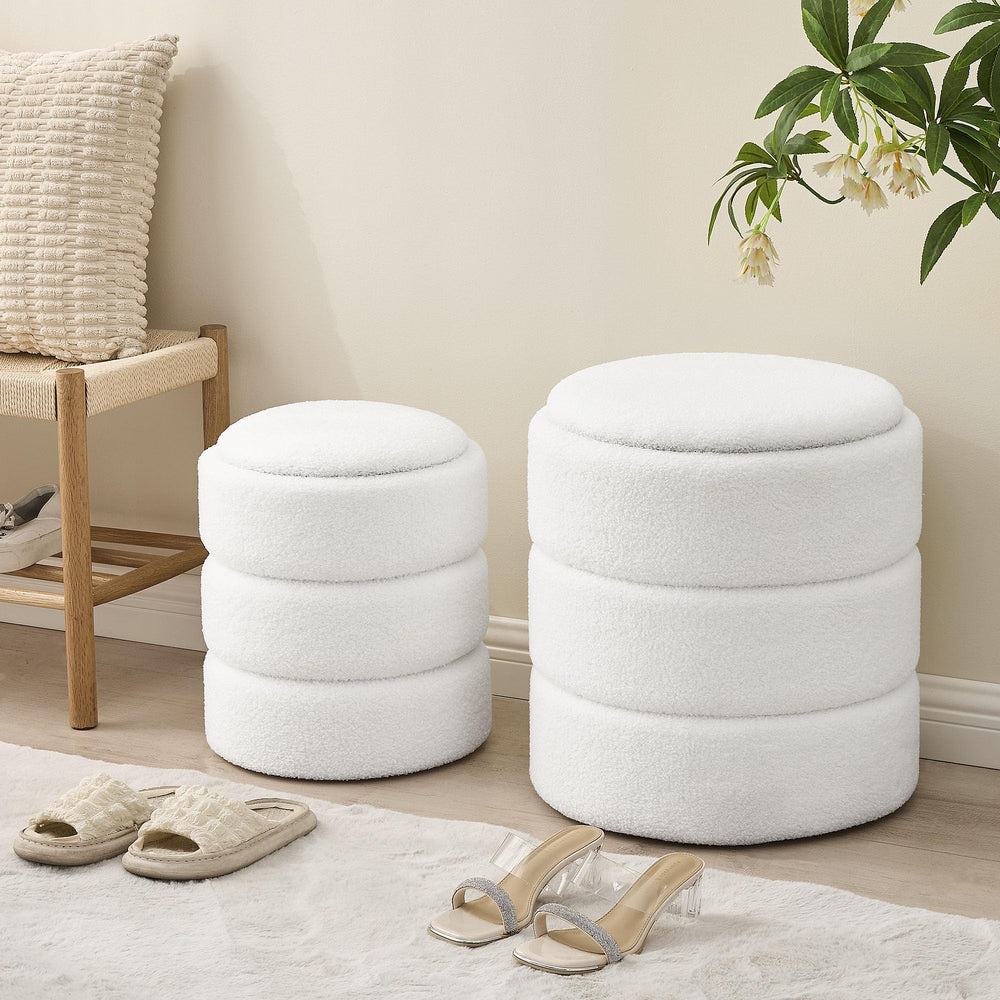 Two stylish, white, plush fabric storage stools with a whimsical plush tiger toy and a cozy yellow throw on one.