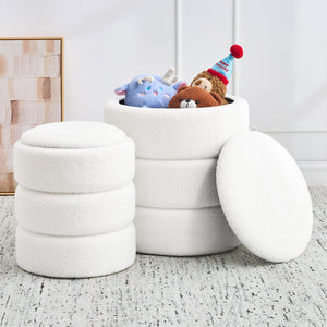 A stack of three plush white storage ottomans, one opened with colorful stuffed animals peeking out, on a textured rug.