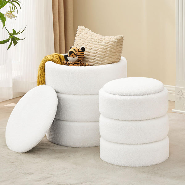 Two stylish, white, plush fabric storage stools with a whimsical plush tiger toy and a cozy yellow throw on one.