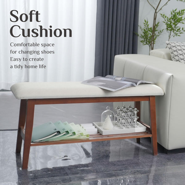 A stylish bench with a soft cushion, perfect for changing shoes, featuring a shelf for storage and decor in a modern living room.