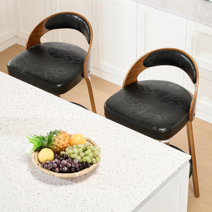 Viroformo swivel bar stools in black faux leather with solid wood legs at a kitchen island, complemented by a fruit bowl.