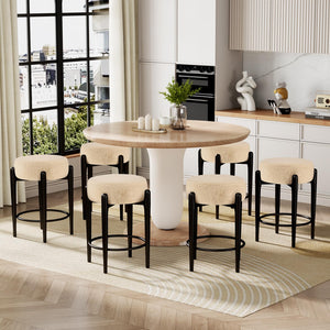 A modern dining space features a round wooden table surrounded by six black and beige upholstered stools, with a garden view outside.