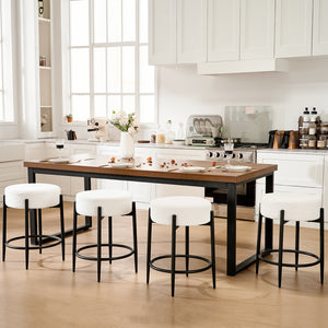 A modern kitchen featuring a wooden dining table and four fluffy white stools, adorned with flowers and elegant table settings.
